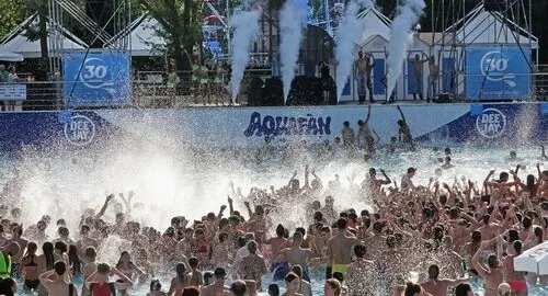 Ragazzi e ragazze si divertono nella grande piscina a onde del parco acquatico a Riccione